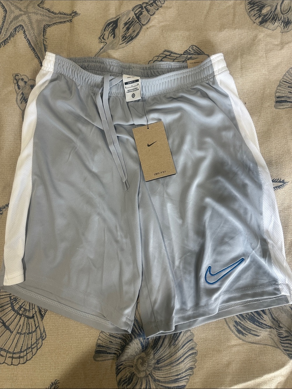 Nike Men’s Gray Athletic Shorts with White Side Panels and Blue Swoosh